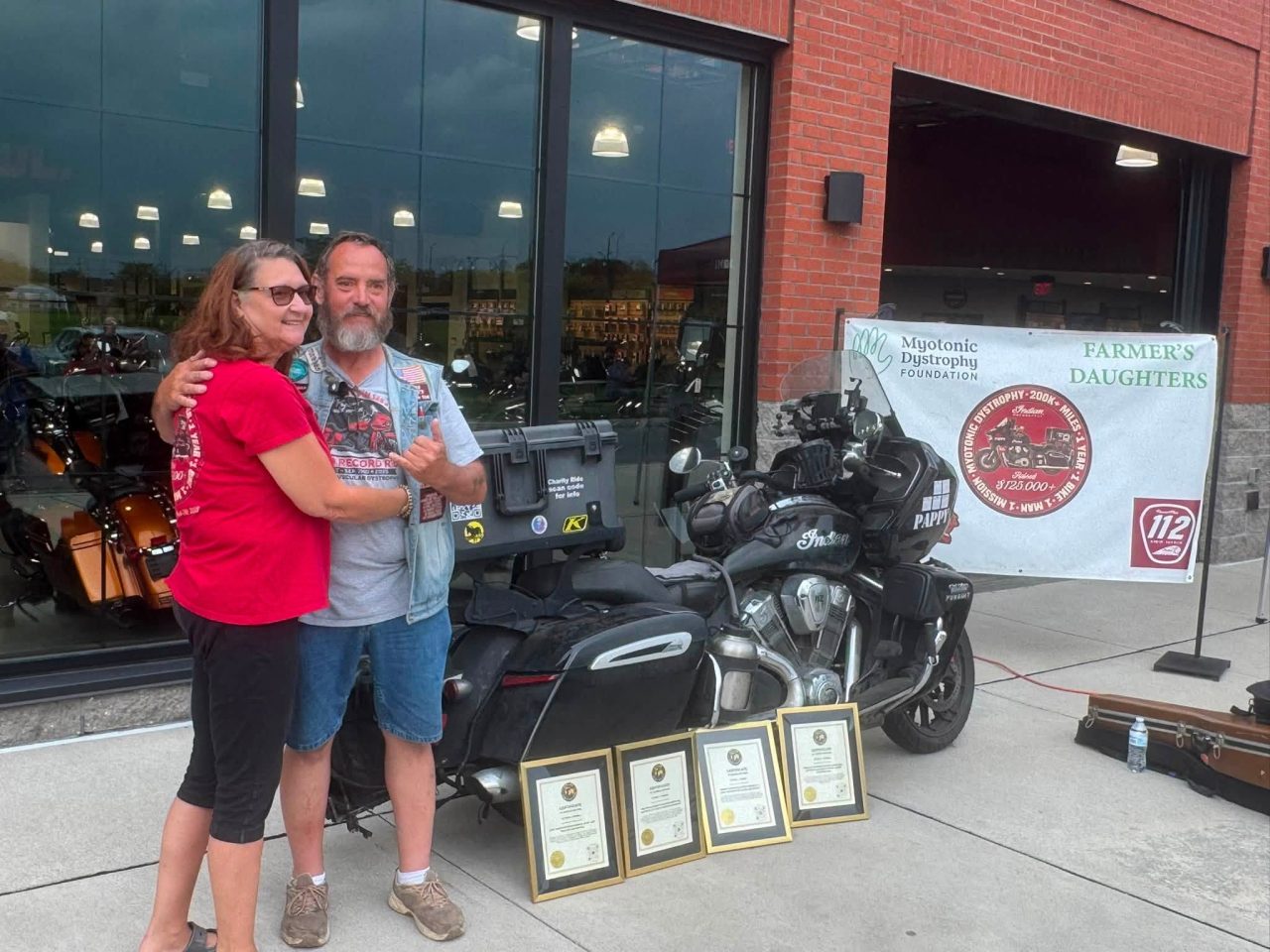 Cornell with his bike, wife and awards