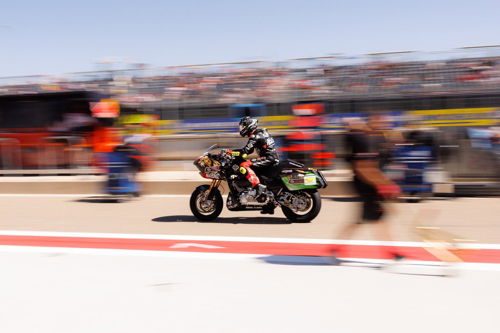 Andrea Iannone riding through pit lane in Aragon.