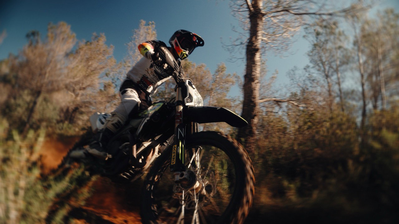 A Triumph MX bike flying through the dirt