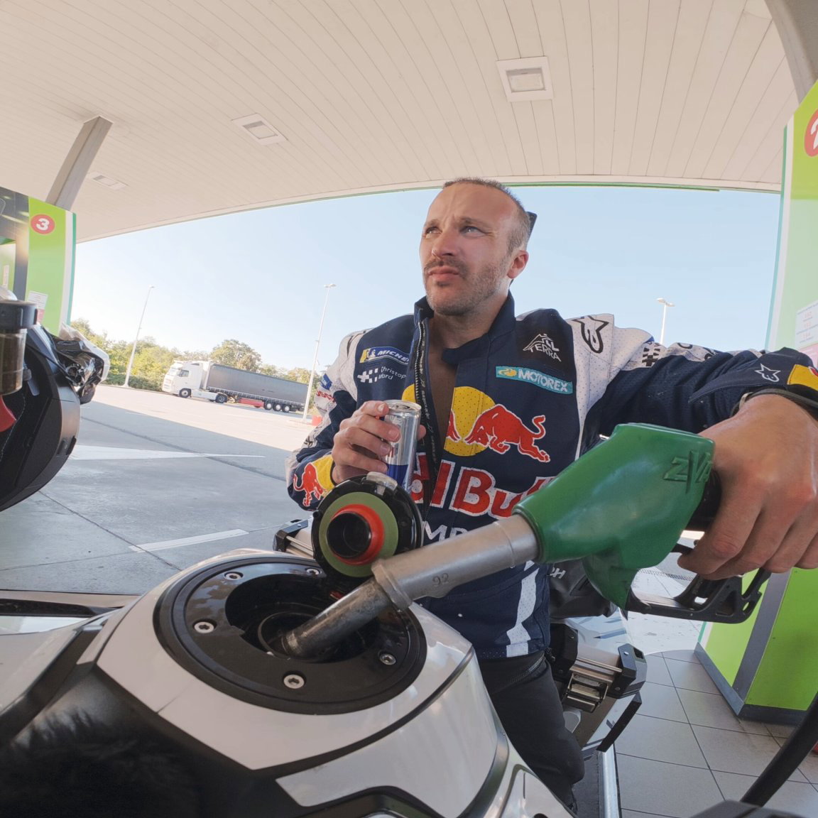 Sam filling up his Tiger 1200 in Serbia | Baptiste Fauchille / Red Bull Content Pool