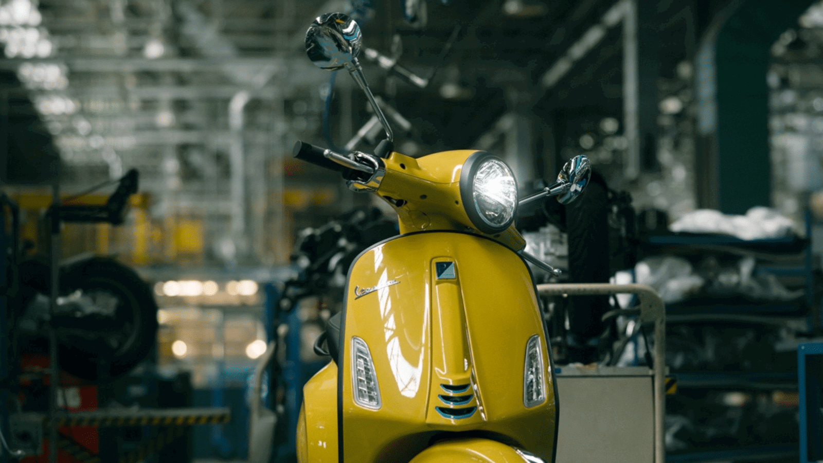 Yellow Vespa Primavera scooter.