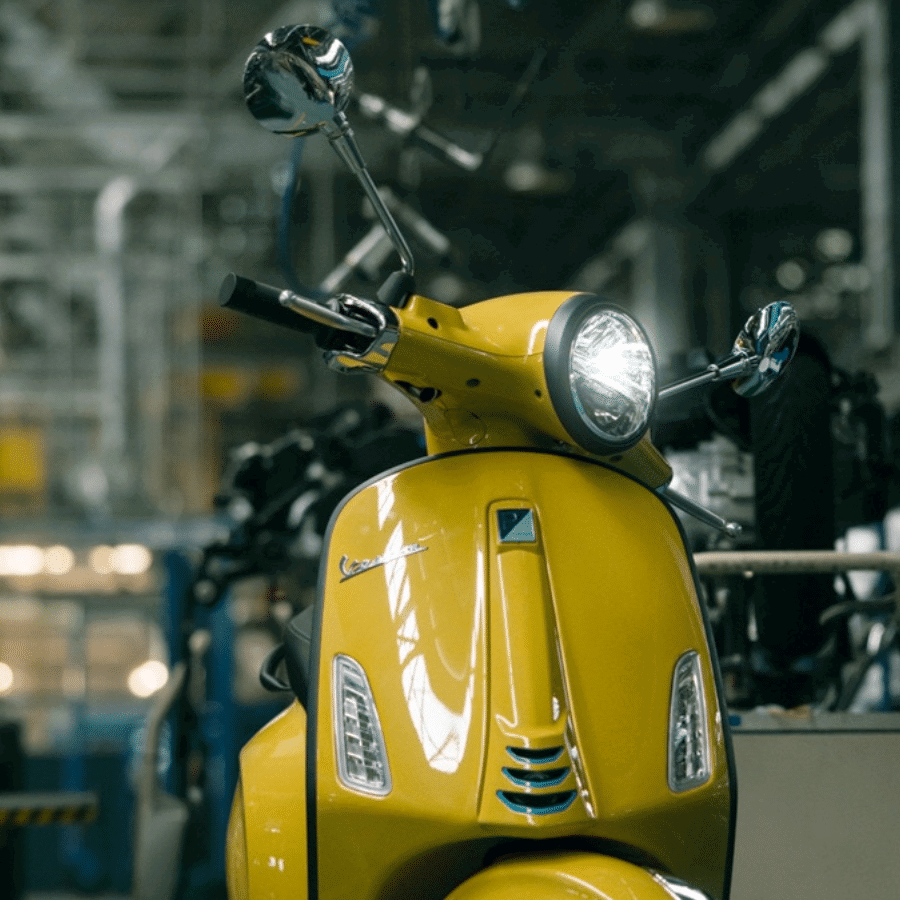 Yellow Vespa Primavera scooter.