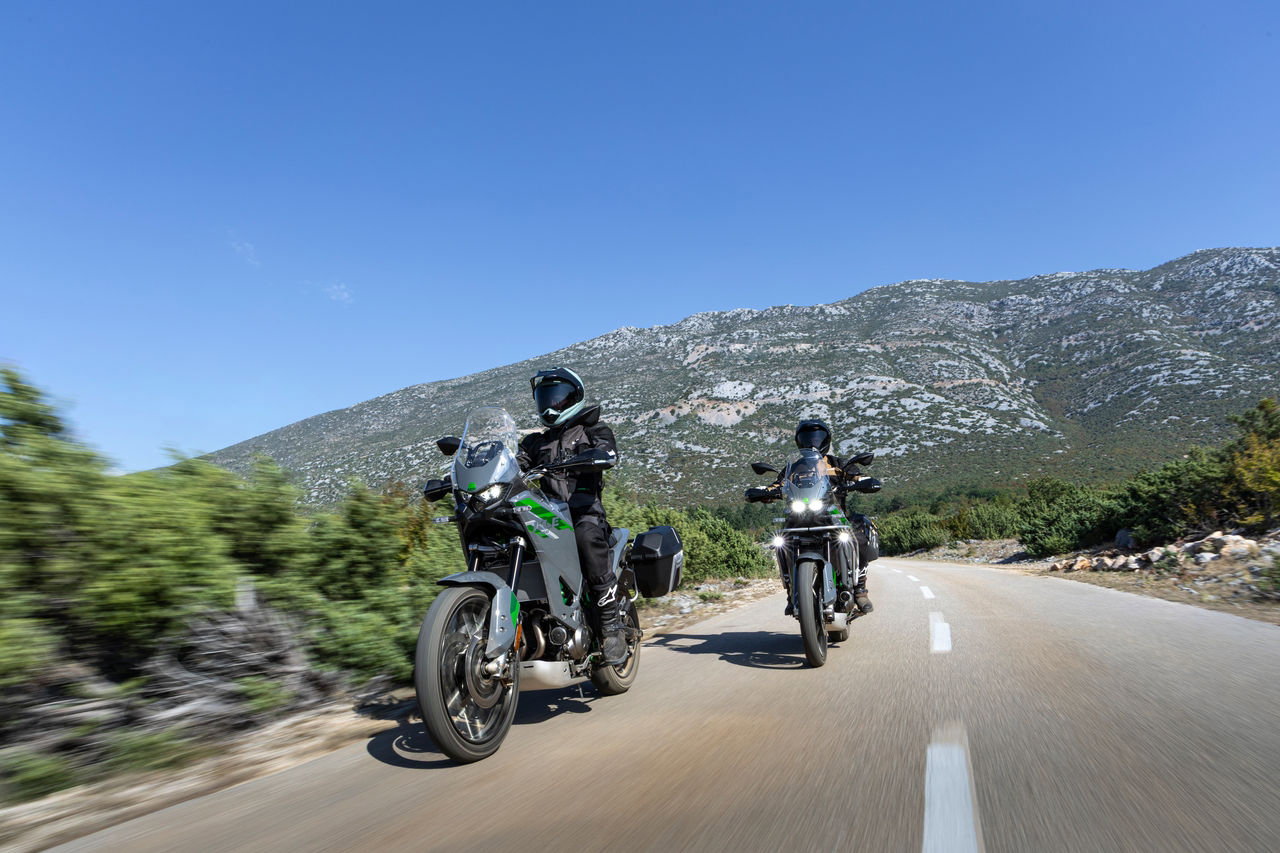 Kawasaki KLE650 bikes on the road.