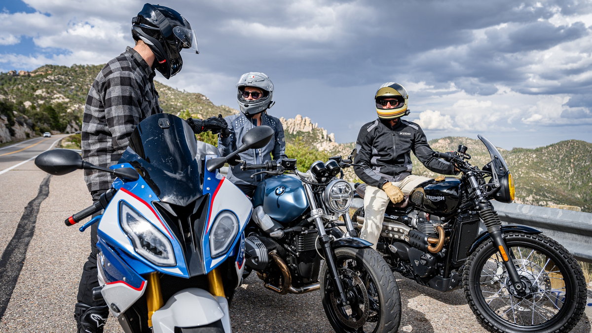 Motorcyclists using Sena intercom systems at the side of a road.