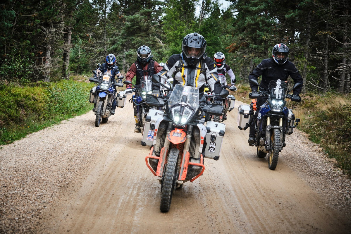 A group of motorcyclists riding off-road.