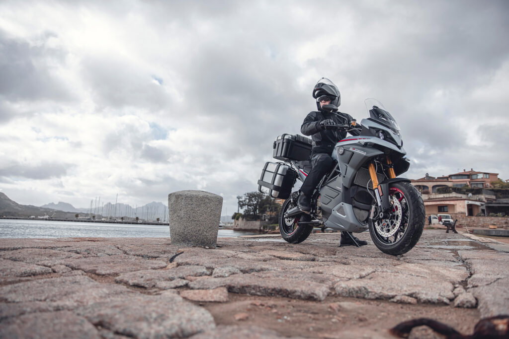 Experia electric sports touring motorcycle parked on some rocks