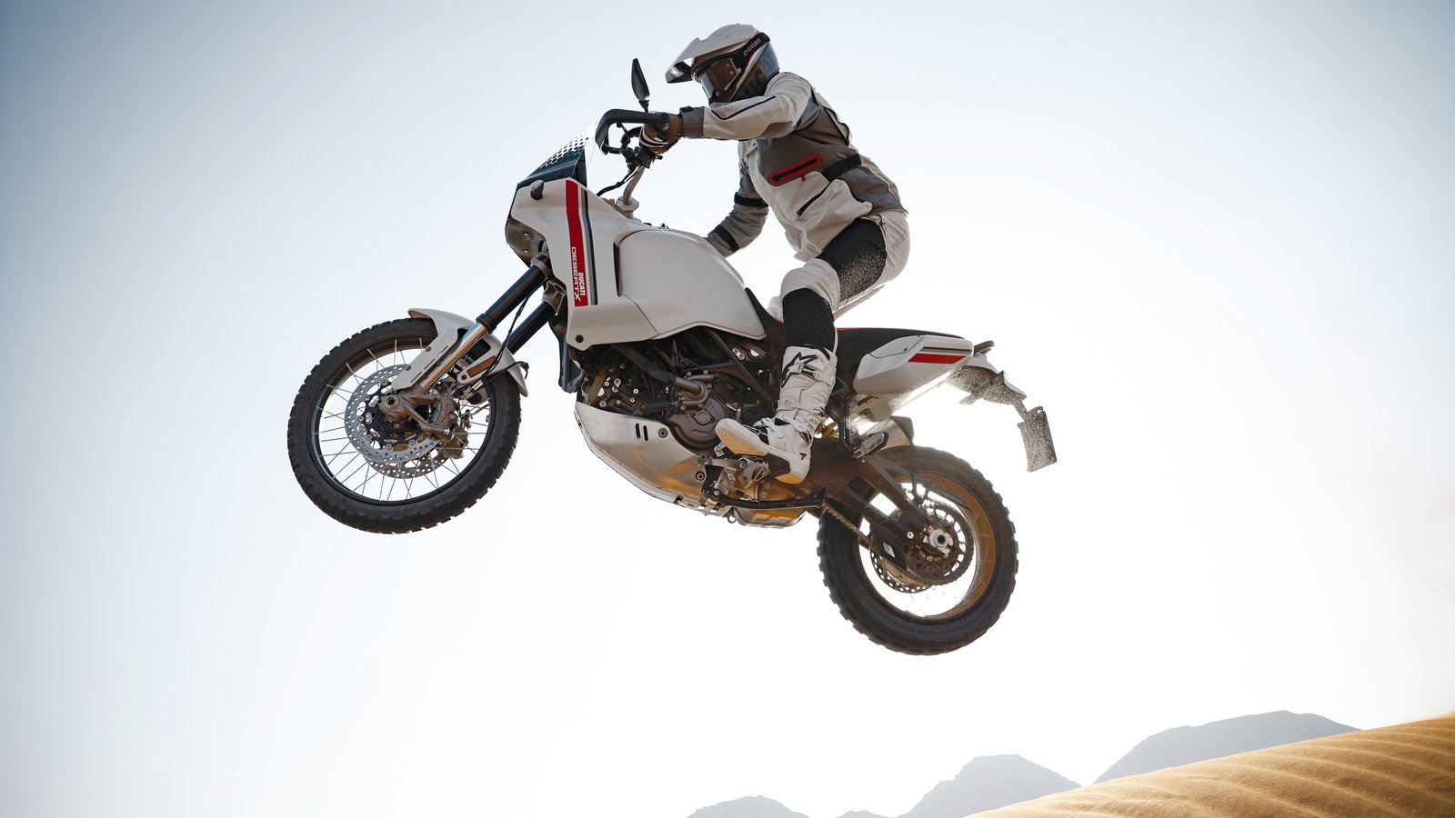 Ducati DesertX jumping through dunes