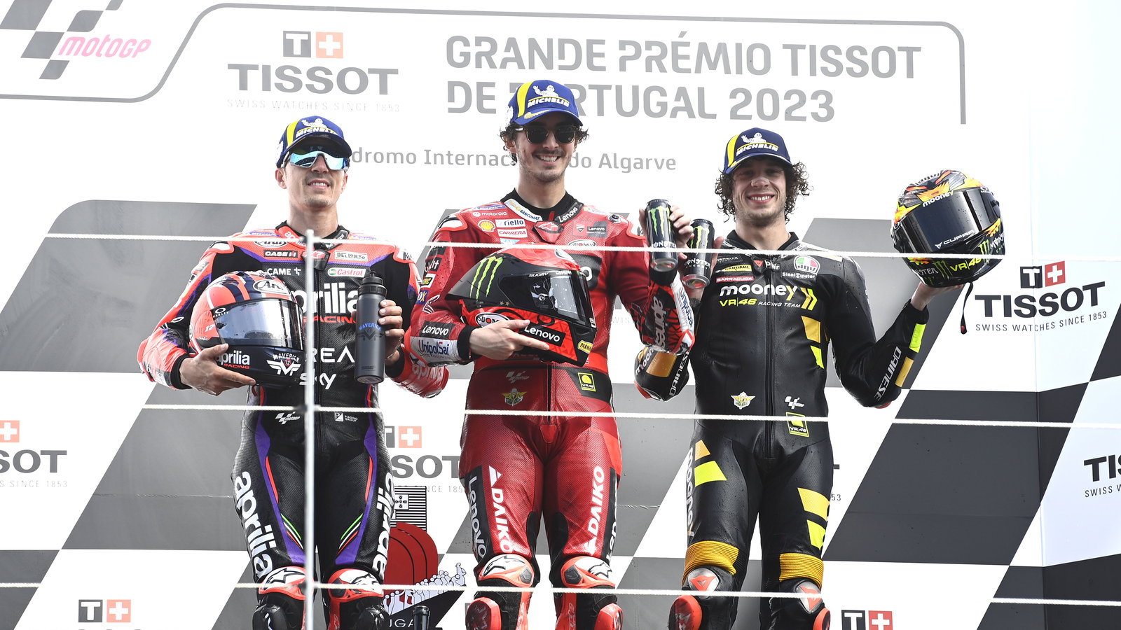 Francesco Bagnaia, Maverick Vinales, Marco Bezzecchi, on 2023 MotoGP Portuguese Grand Prix podium. - Gold and Goose