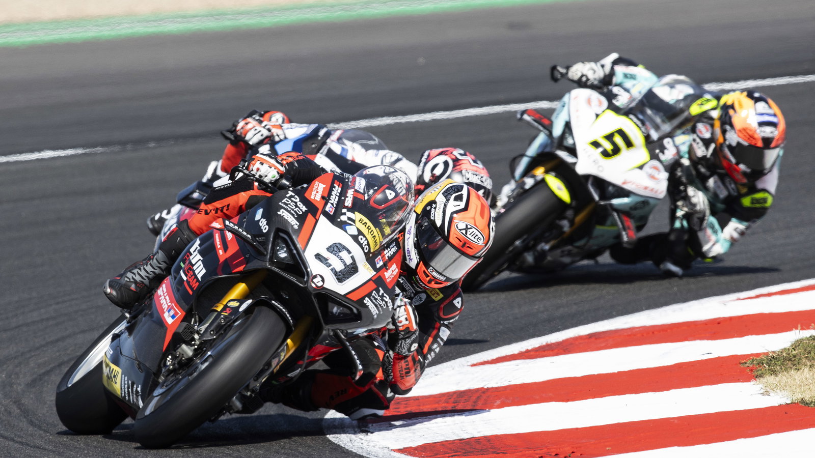 Danilo Petrucci leads Scott Redding, Philipp Oettl, 2023 French WorldSBK. - Gold and Goose