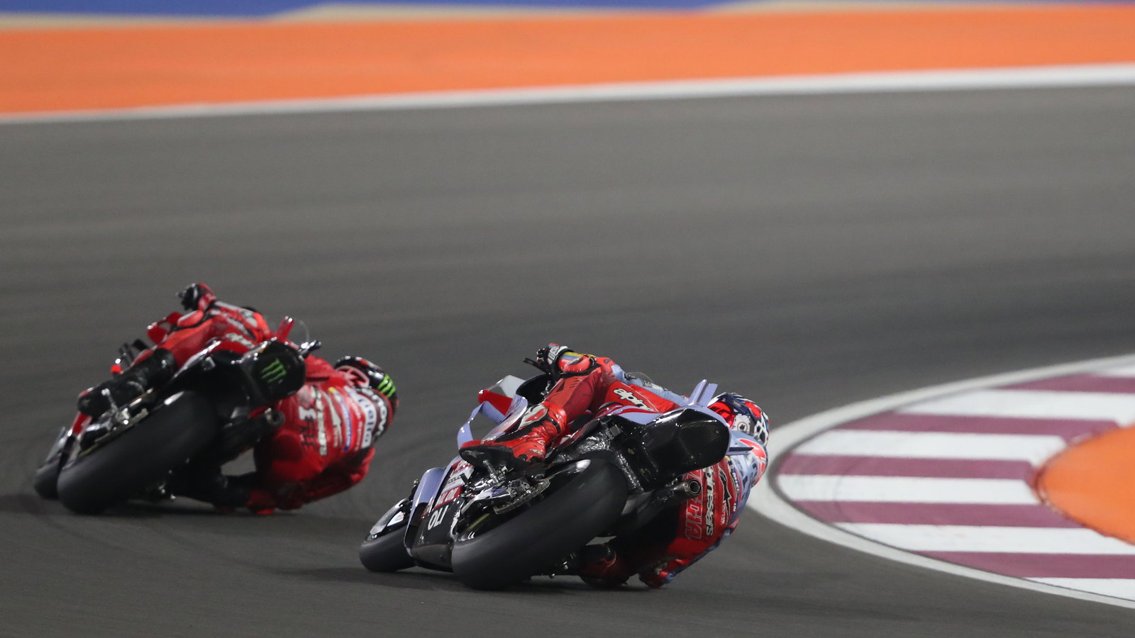 Fabio Di Giannantonio chases Francesco Bagnaia, 2023 MotoGP Qatar Grand Prix. - Gold and Goose