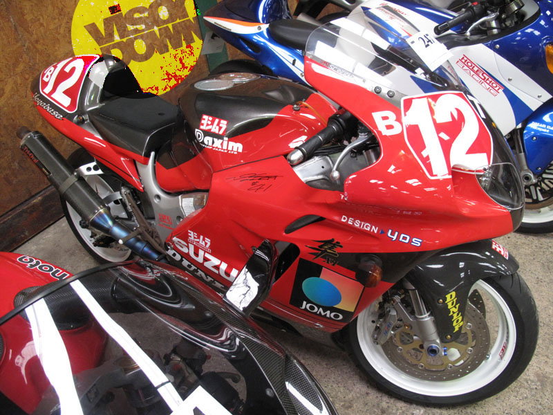 Hit Girl rides a purple Panigale