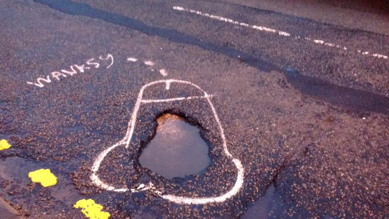 Campaigner highlights potholes by drawing penises around them