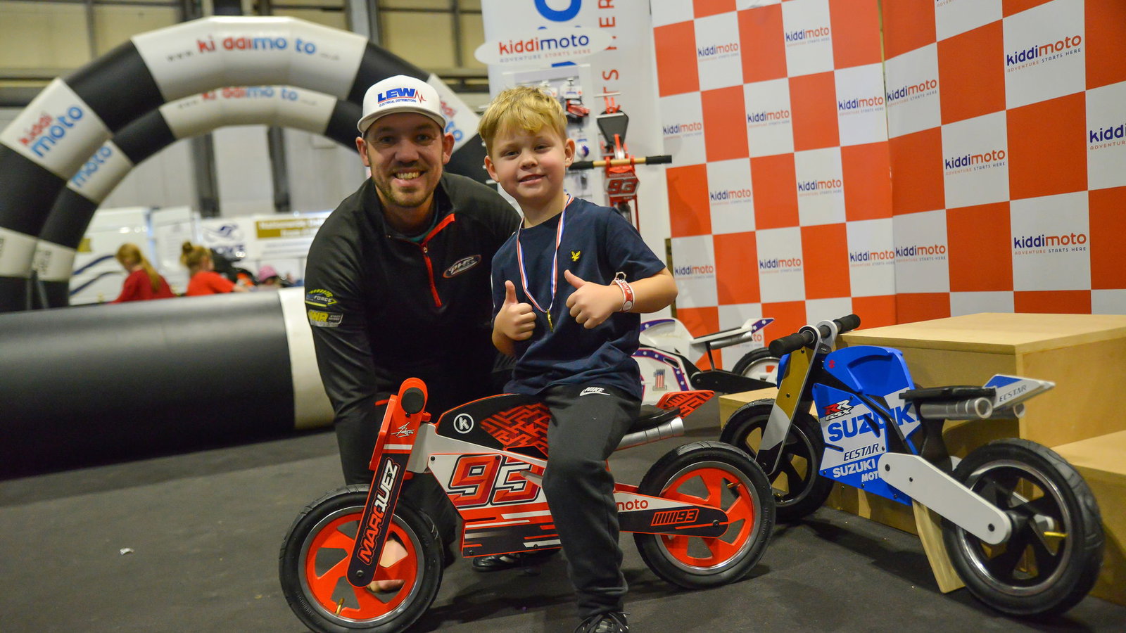 Peter Hickman and small blonde child on Kiddimoto bike