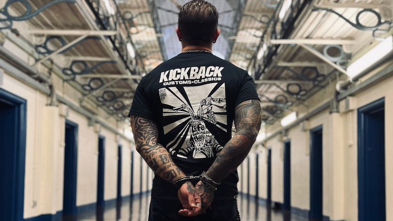 A biker in a prison while handcuffed